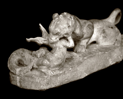 Photo of original plaster Caproni cast of a tiger devouring a crocodile on a black background