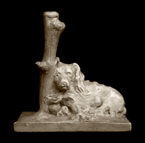 Photo of a Caproni Plaster cast original sculpture of a sleeping dog with it's head against a log on a black background
