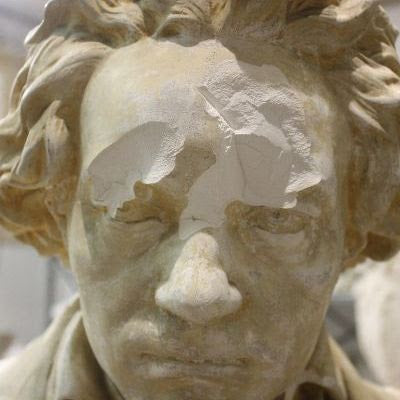 closeup photo of face of yellowed, damaged plaster cast sculpture bust of Hagen's Beethoven