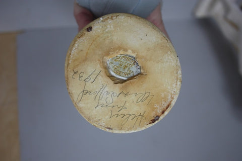 photo of bottom of small bust plaster cast by P.P. Caproni and Brother showing embedded metal hallmark