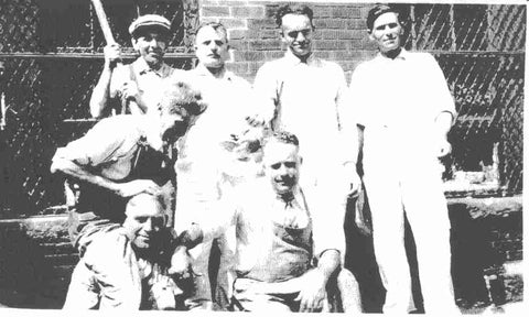 black and white photo of seven men from P.P. Caproni and Brother posing for a photo