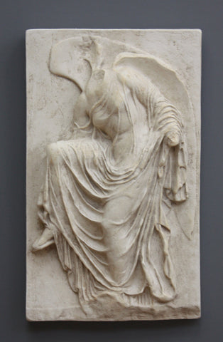 photo of cast of sculpture relief of robed figure, head now missing, reaching for her sandal in Light Antique Plaster Patina on a dark gray background