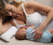 women laying on floor breastfeeding baby