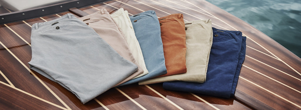 Picture of different colours of Alberto Pants placed right next to each other on a boat
