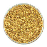 Yellow and brown mustard seeds are stone ground