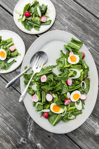 Salt Water Farm's dandelion salad on a handmade ceramic Farmhouse Oval Platter and Silverlake salad plates.