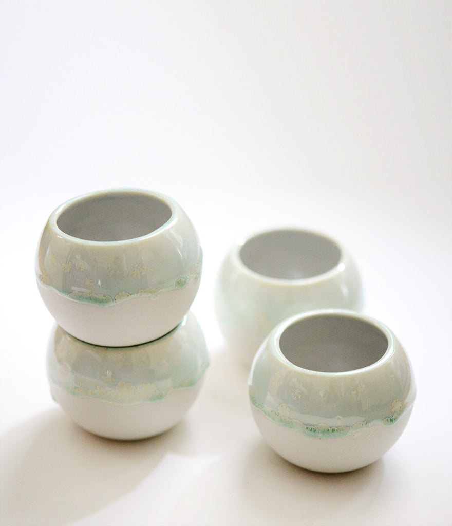 porcelain buoy vessels, porcelain crystalline glaze, drippy glaze on porcelain, porcelain and stone