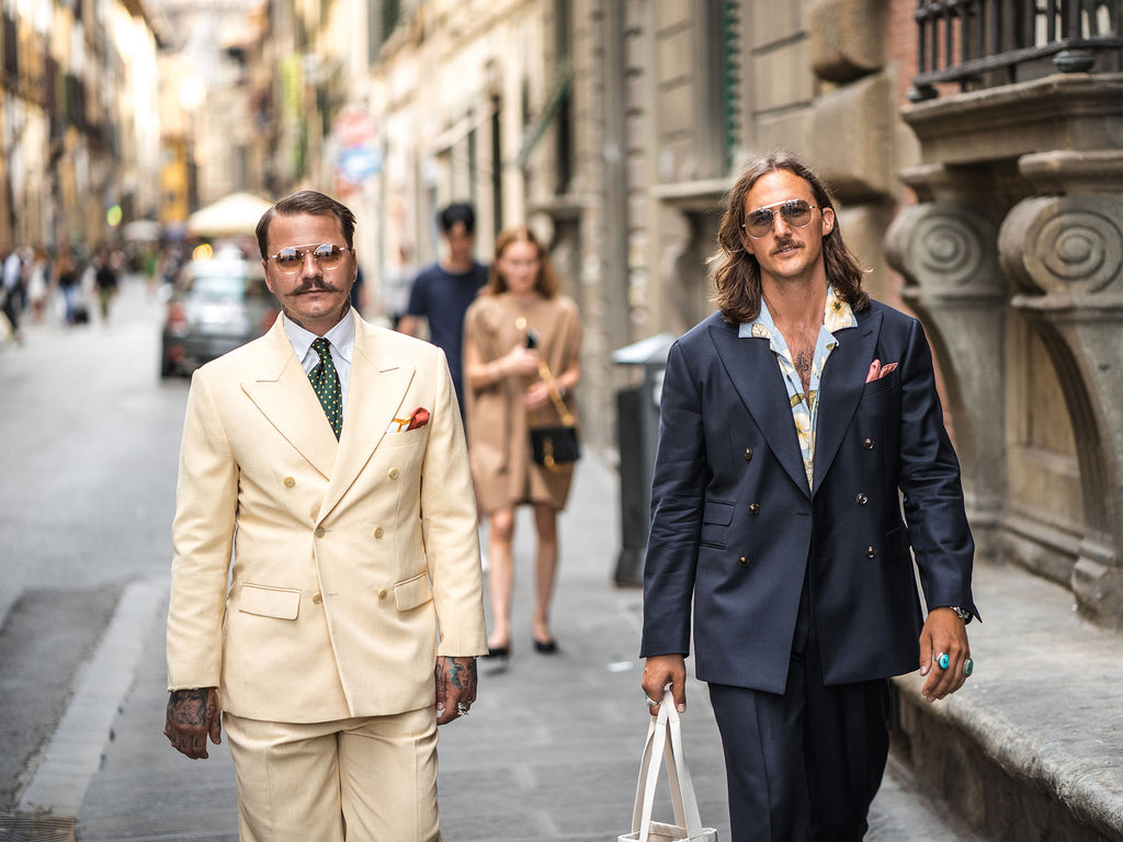 suited men on the street with tattoos