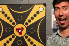 Excited KOOBA player sticks out his tongue and pulls a funny face in front of the board.