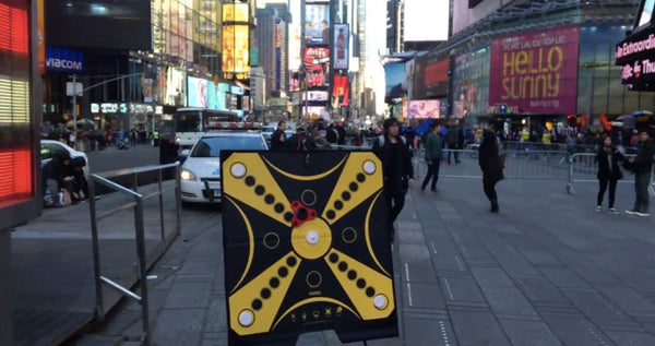 The KOOBA game board stands proudly in the bright lights of Times Square in New York City.