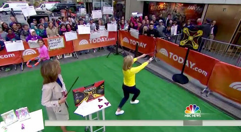 TODAY show toy expert Meredith Sinclair aims her shot at the KOOBA board while Hoda looks on in the plaza.