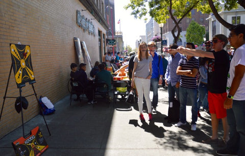 Crowd gathers round to see a KOOBA shot demonstration in the sunshine. 