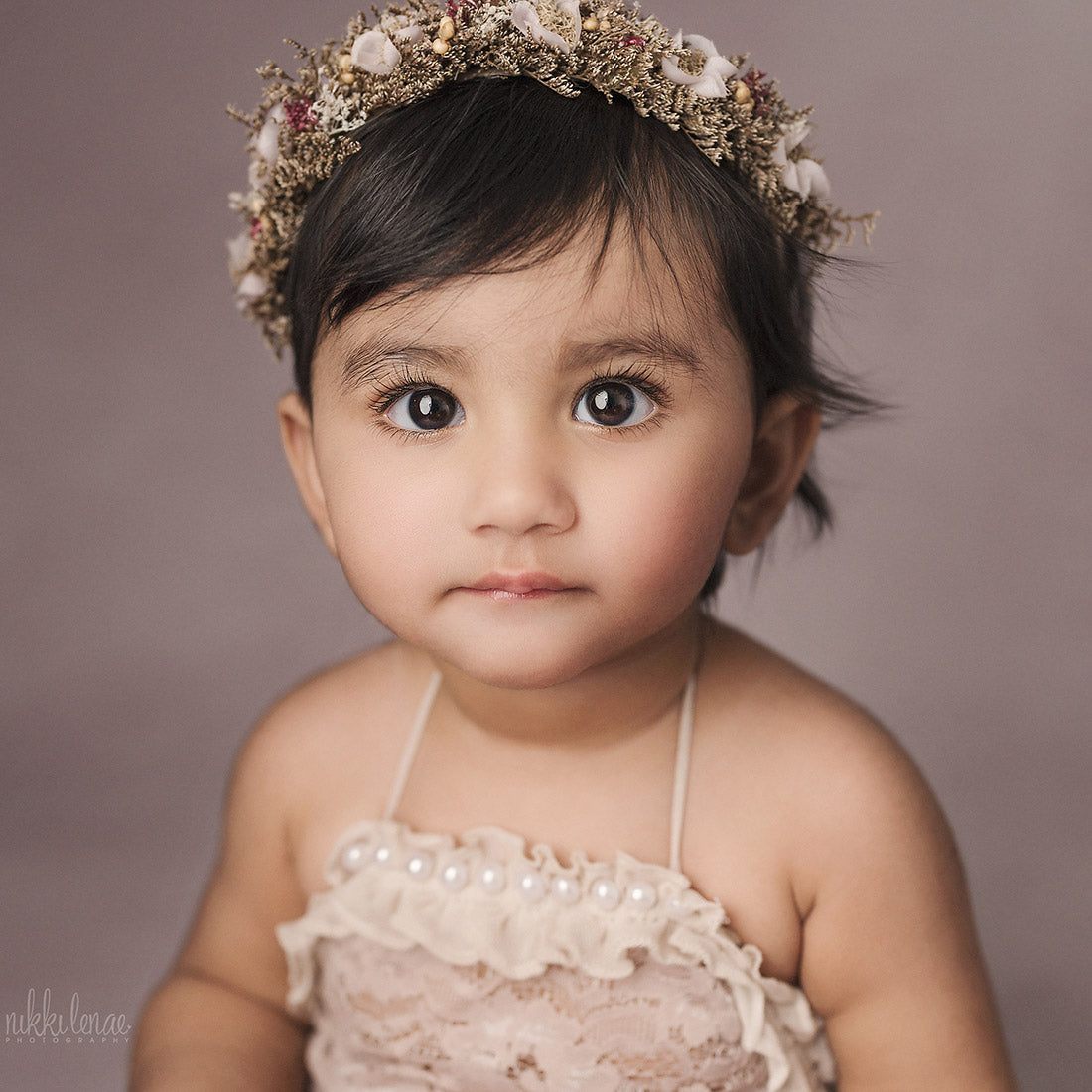 Close up image of a baby shot on the Pink Cape Light backdrop