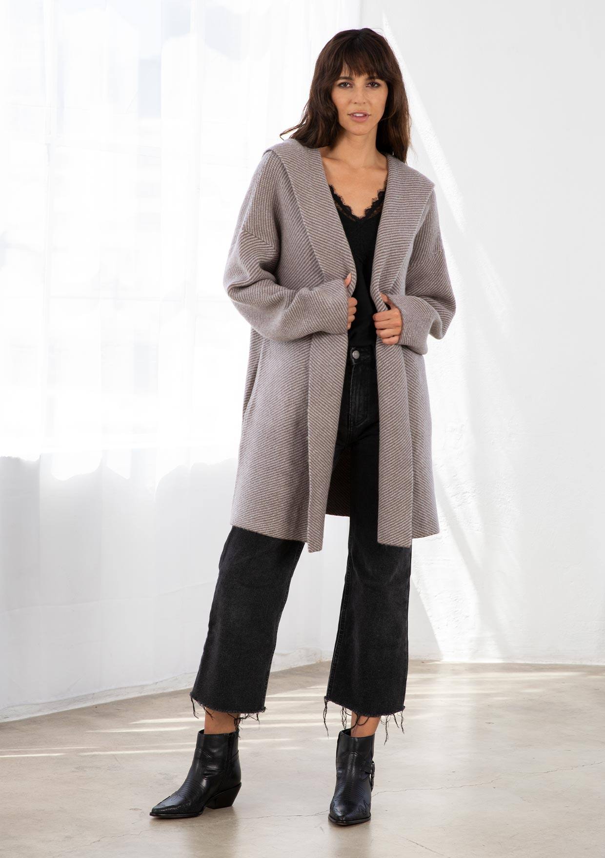 [Color: Mocha/Grey] A model wearing a cozy mocha brown oversize mid length cardigan. With side pockets, an open front, a shawl collar, and a hoodie. 