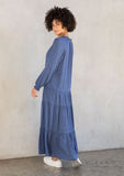 [Color: Indigo Blue] A model wearing an elegant and classic indigo blue bohemian peasant maxi dress in floral jacquard. Featuring a dropped waist, a tiered skirt, and a split v neckline with tassel ties. 