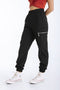 Pantalón jogger de fit ligeramente oversized, pretina y bajo elásticos, cintura media, bolsillos delanteros y laterales decorativos con cremallera en contraste.