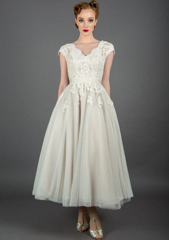 Polly is a tea length wedding dress with vintage inspired lace and tiny dot tulle