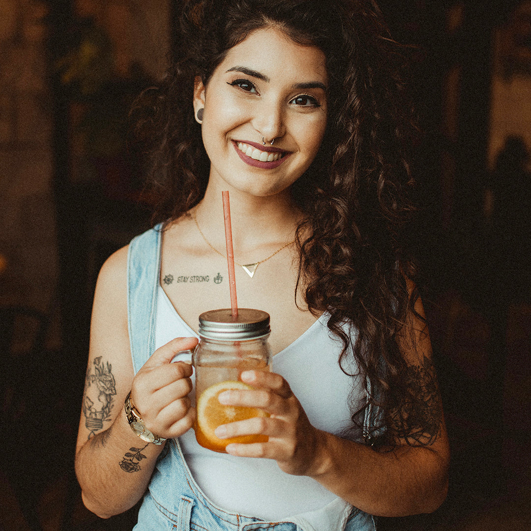 woman with tattoos drinking Good Earth Sweet & Spicy Tea