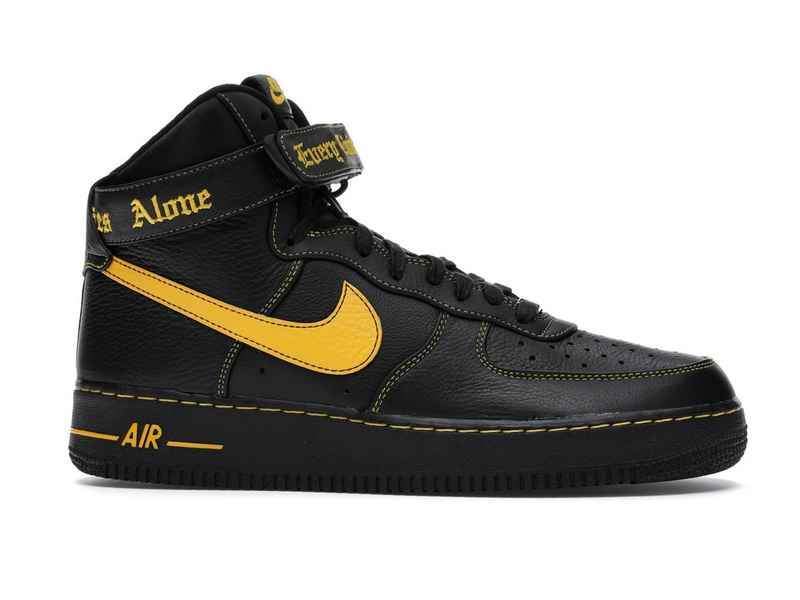 black nike with yellow swoosh