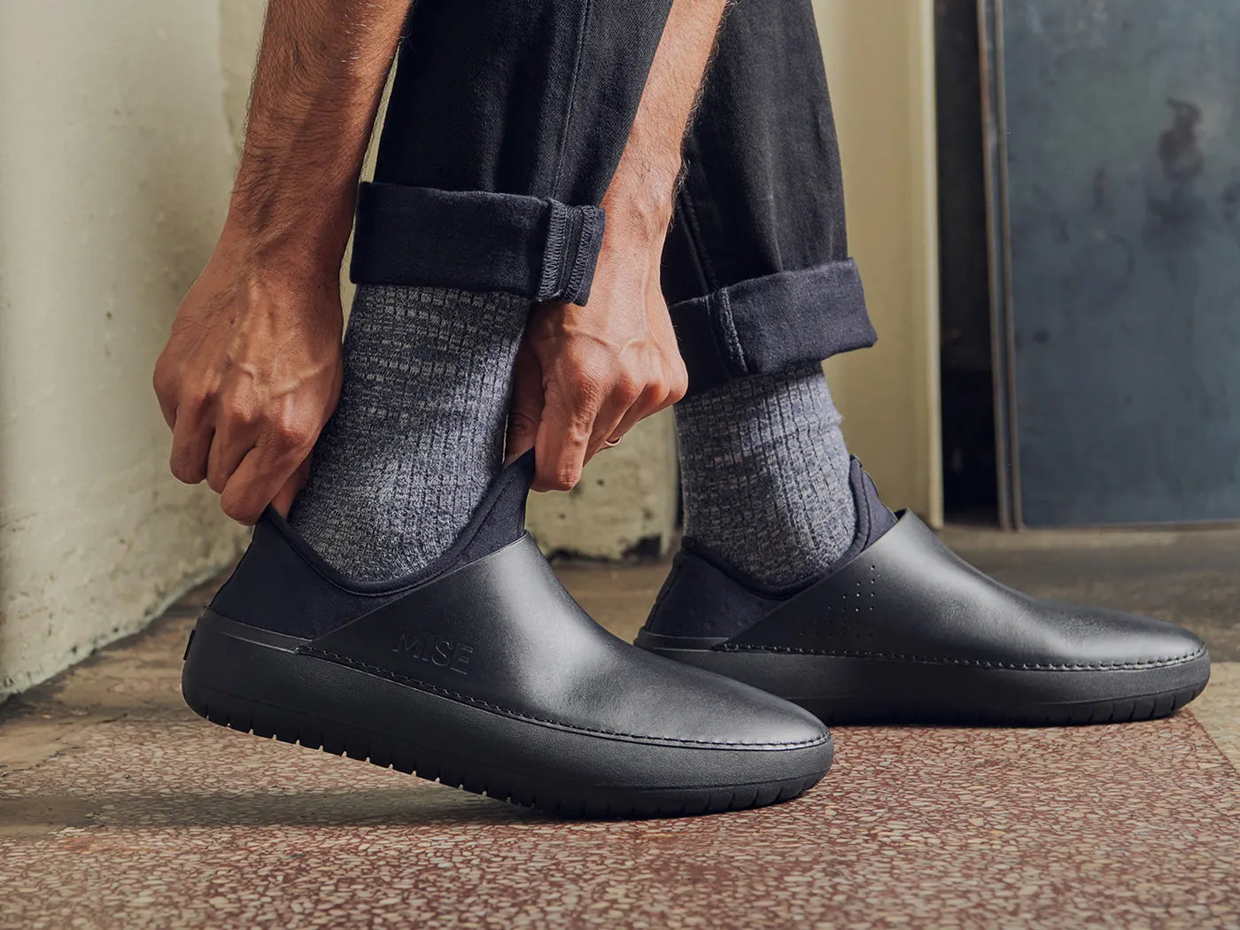 MISE Standard black non-slip kitchen shoes being put on foot