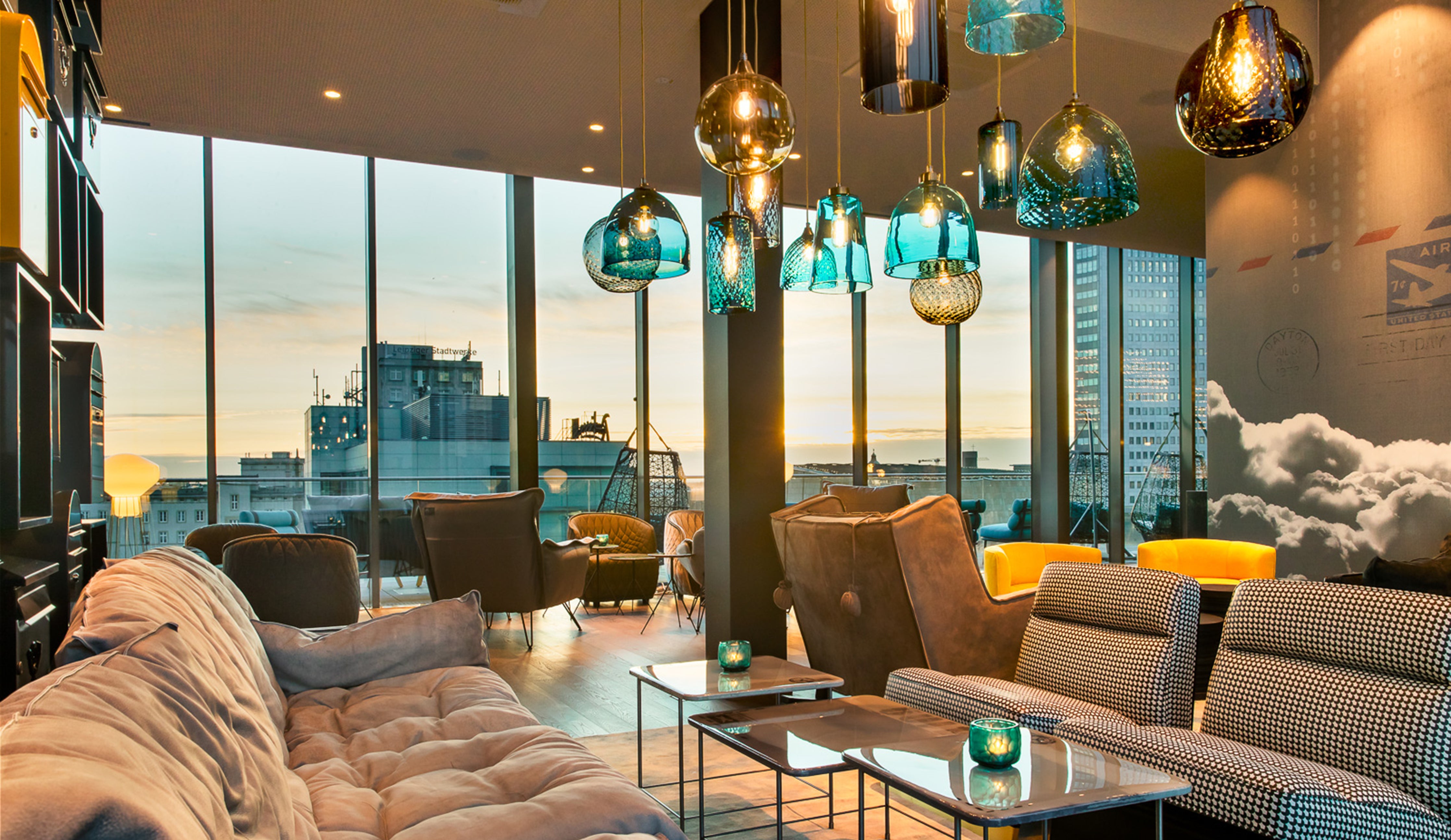 Rothschild &amp; Bickers Pick-n-Mix pendants in large cluster over table at Motel One Leipzig Post