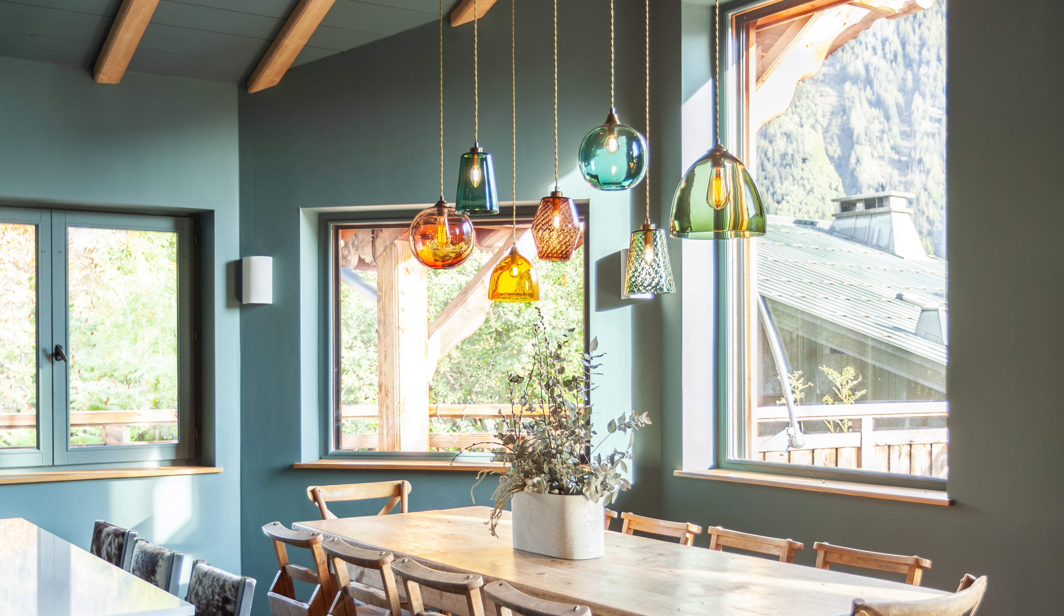 Pick-n-Mix pendants in a mix of sizes, colours and textures by Rothschild &amp; Bickers, hanging in cluster over dining and seating area of ski chalet