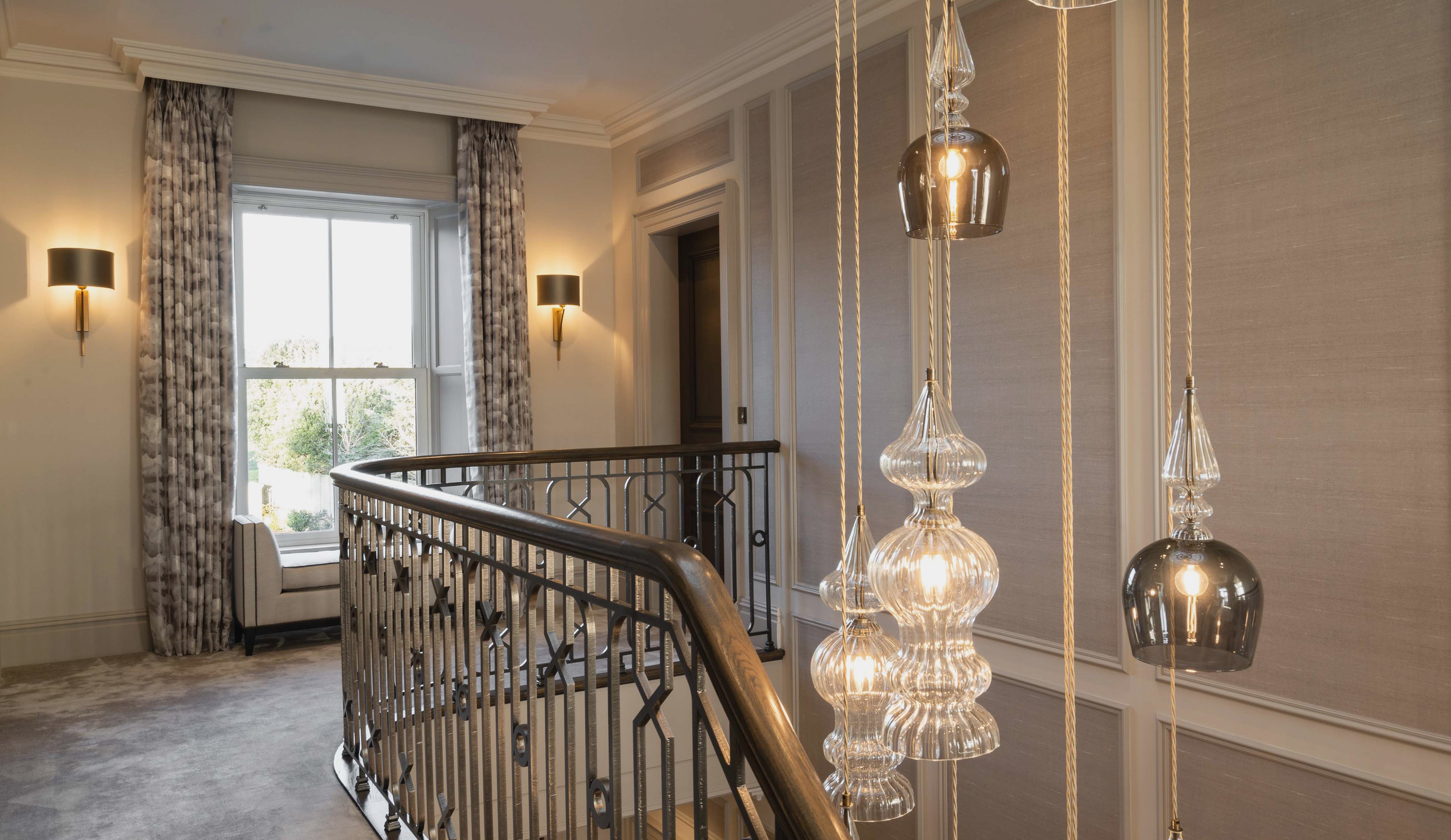 Blown glass pendant lighting by Rothschild &amp; Bickers suspended in a stairwell 