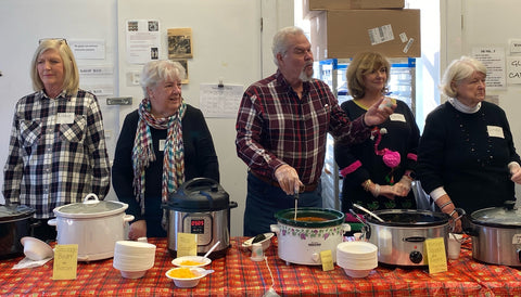 Volunteers lined up to serve soup in the pottery studio