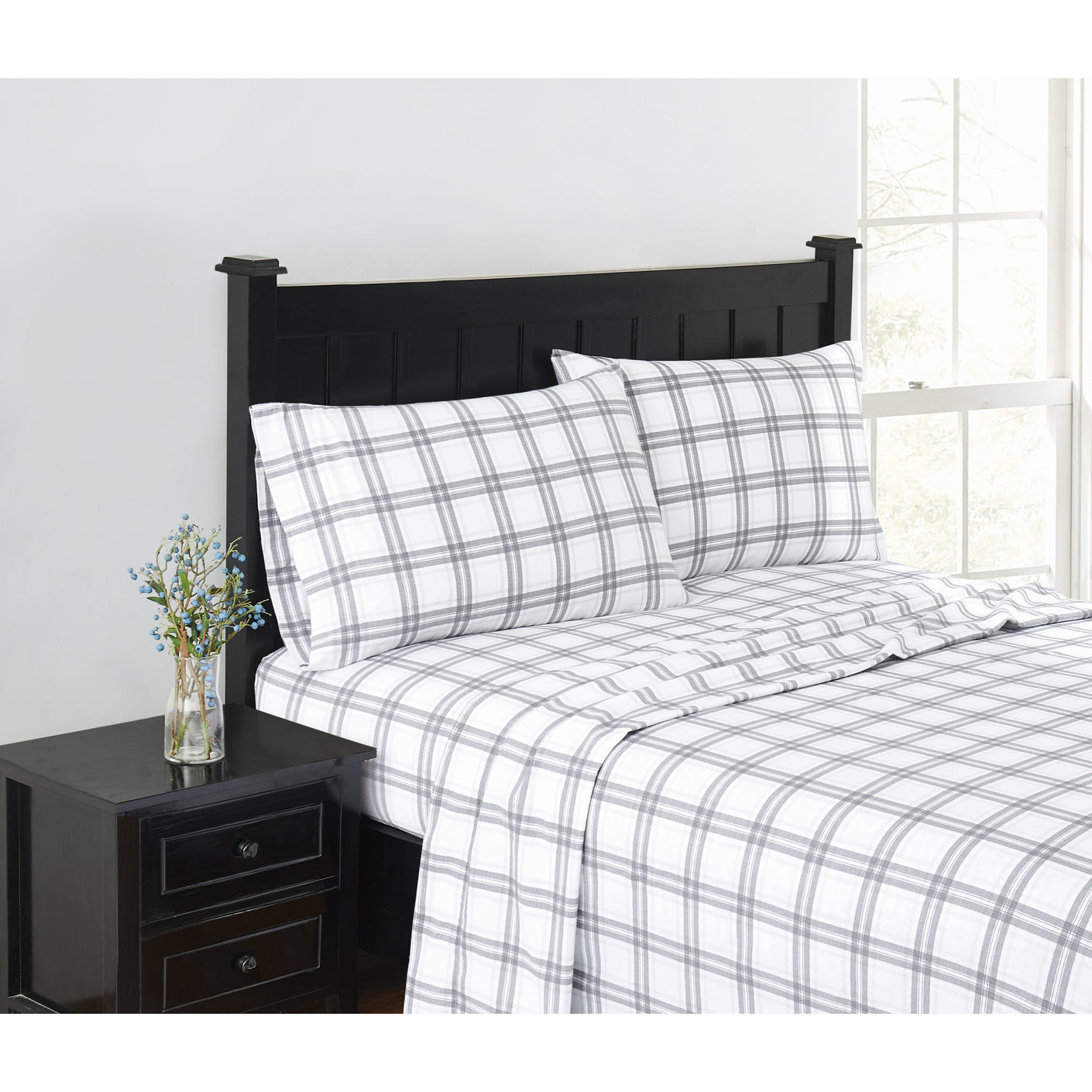 plaid flannel beadings on a black bed