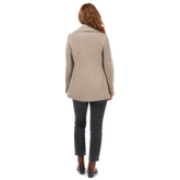  back of woman wearing taupe double breasted peacoat with matching scarf
