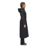 woman wearing black maxi trench coat side view
