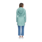  back of woman wearing meadow-colored trench coat with double collar and belt
