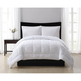  white embossed seersucker comforter on bed
