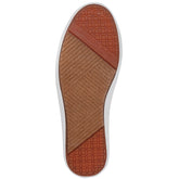  bottom of white slip-on sneaker shoe with periwinkle stripe
