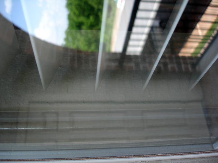 Clean home window with overspray removed using a Klaren Kleanmitt