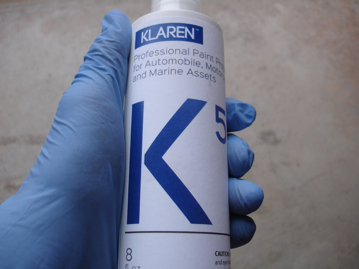 Holding a bottle of Klaren K5 spray wax and sealant