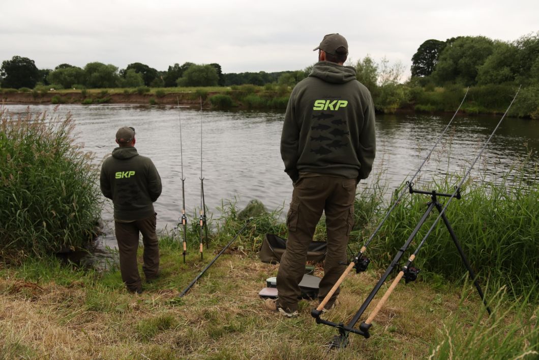 Anglers standing on bank.