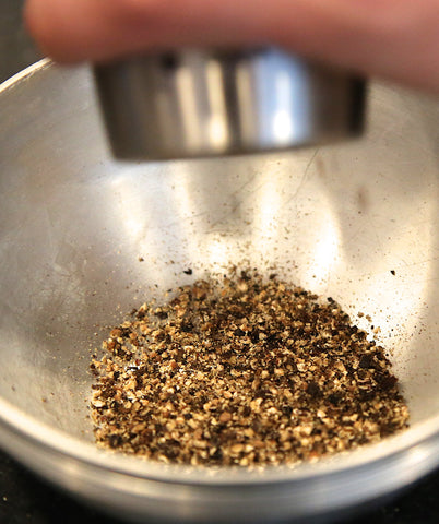 Grinding Reluctant Tellicherry Peppercorns. The aroma is citrus and earthy.