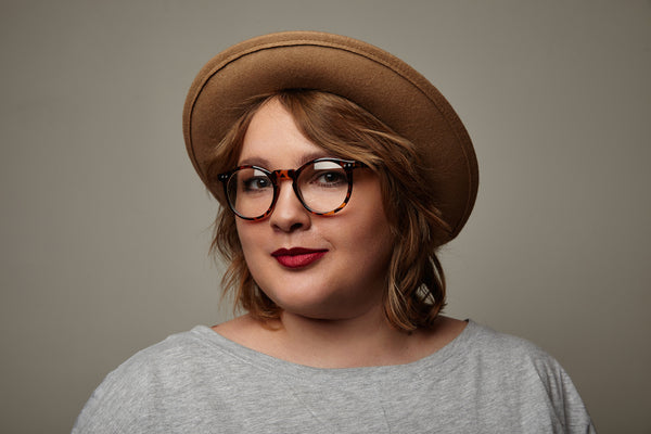 Woman in her 20's with hat and glasses