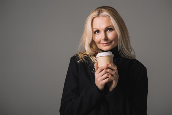 Woman in her late 40's holding a latte