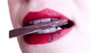 woman with chocolate in her mouth