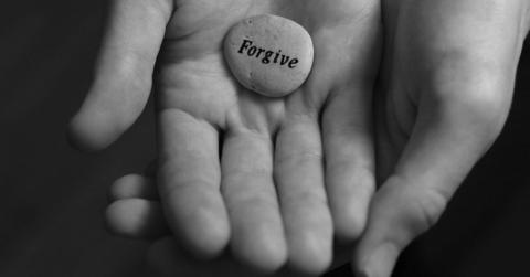 Hands-with-forgive-stone