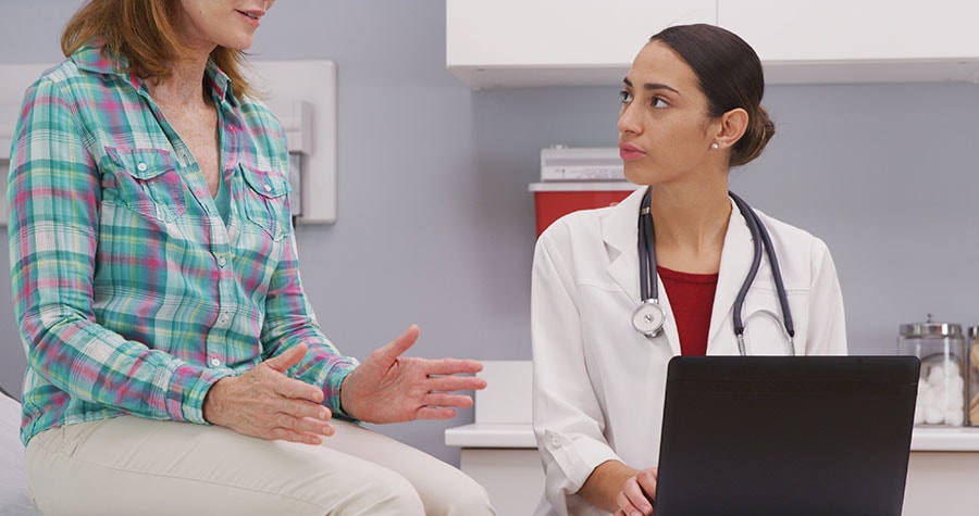 Middle-aged woman talking to her doctor