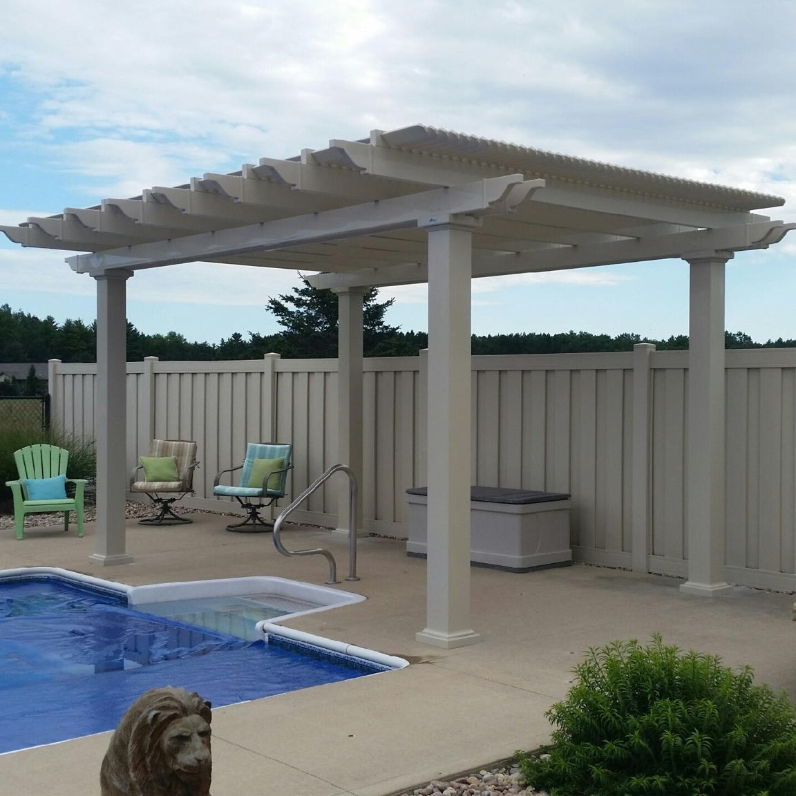 Picture of a tan vinyl traditional pergola providing shade next to a swimming pool