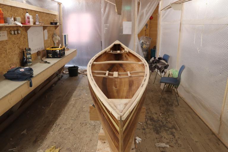 An unfinished woodstrip canoe built using the stapleless method
