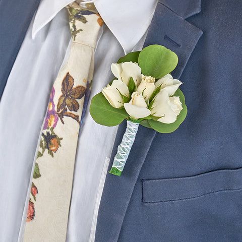 bride and groom wearing blissful white boutonniere roses disbud mum