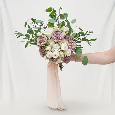 bride and groom holding adore taupe bridal bouquet roses