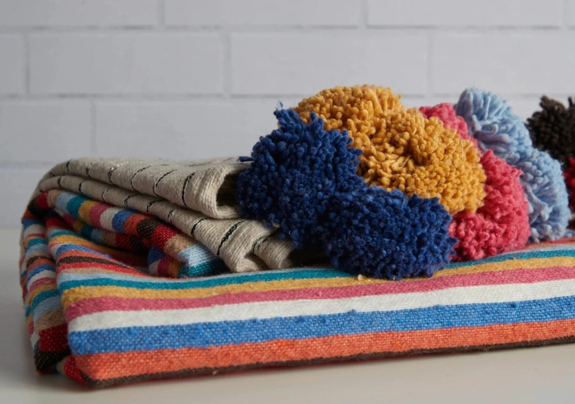 Woven cotton Moroccan blanket with colorful tassels and stripes