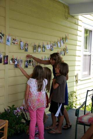 Washi tape decorated clothes pins on photo wall birthday decor