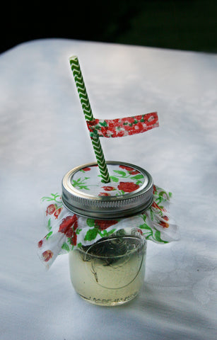 vintage floral cloth covered mason jar with paper straw and floral washi tape flag